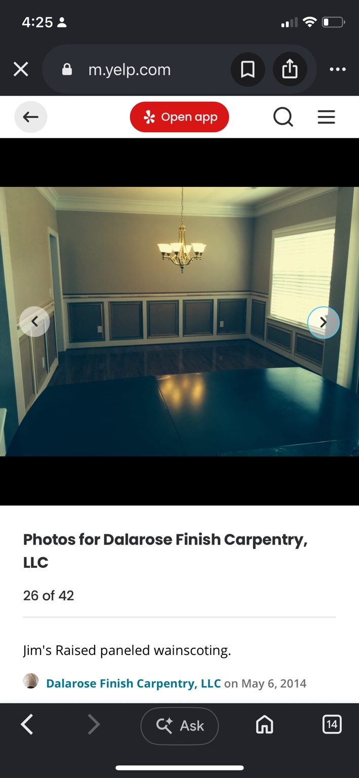 Dining room with contrasting raised-panel wainscoting, crown molding and a chandelier