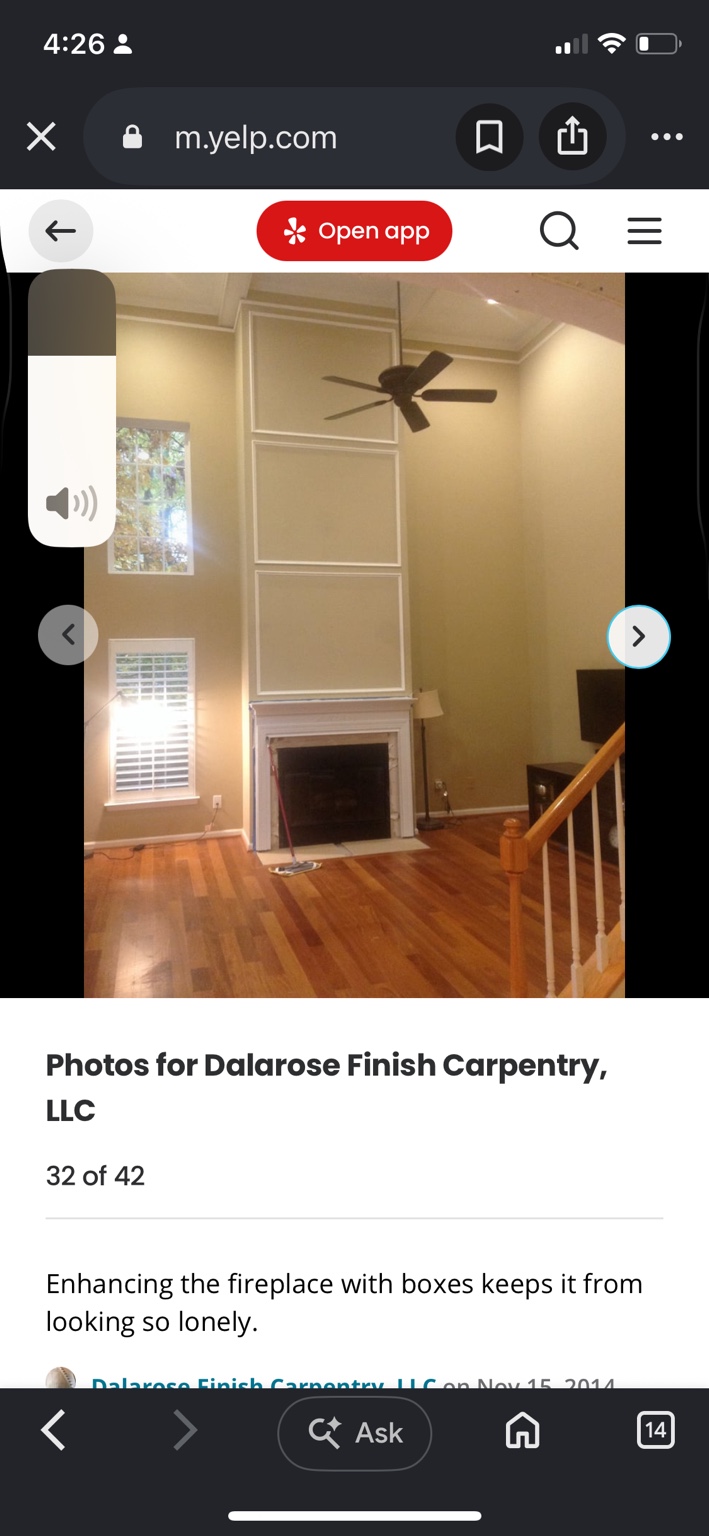 Tall living-room fireplace wall with stacked rectangular molding above a white mantel