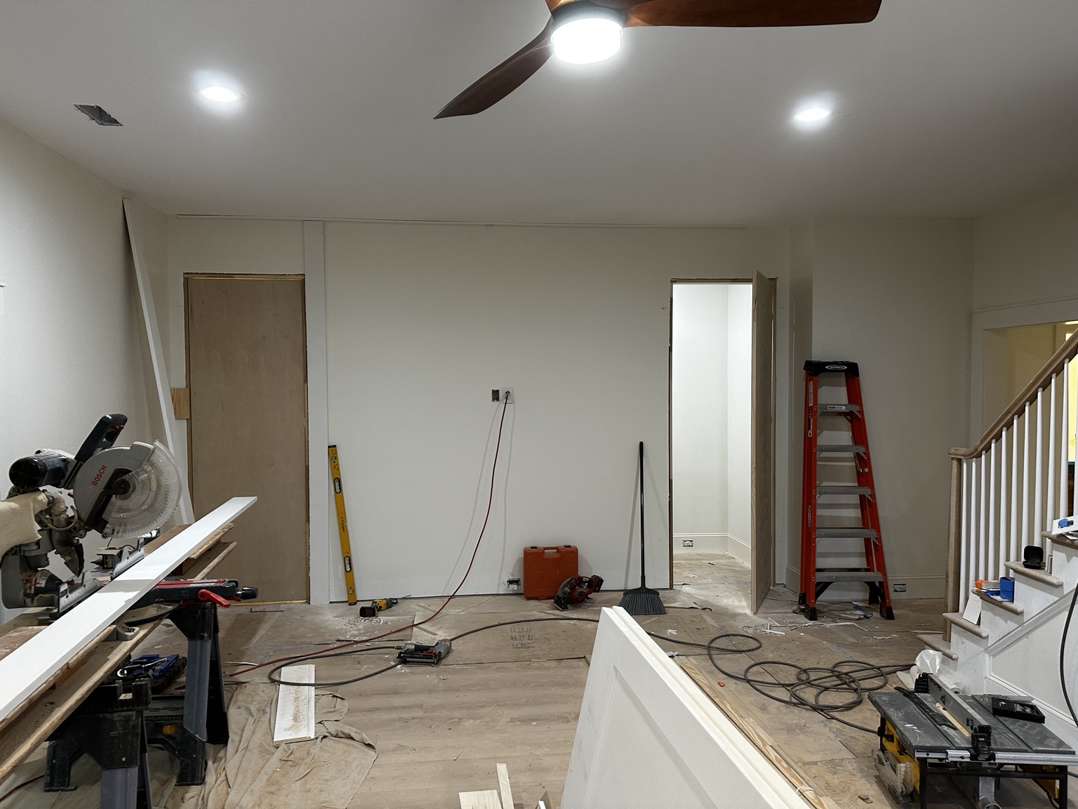 Hidden-door project during construction, showing two doorway openings before wood paneling