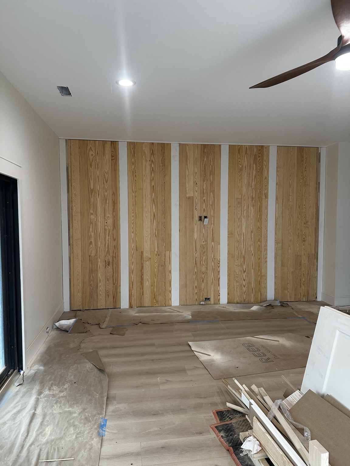 Wood paneling and vertical trim concealing the doorway outlines during construction